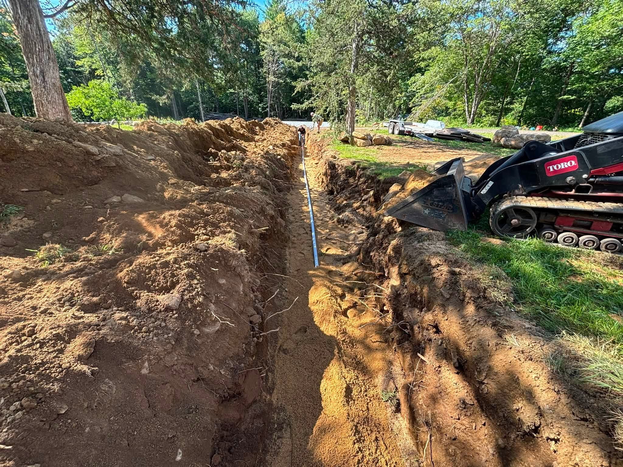 Electrical conduit and water line in trench — Brimfield utility project